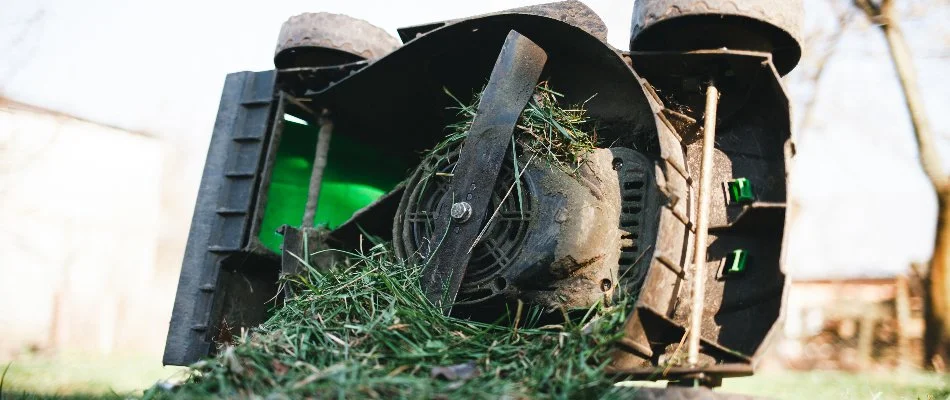 A clogged mower in Delaware, OH, after mowing a wet lawn.