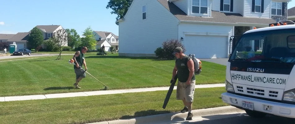 Lawn care professionals working on a lawn in Harlem Township, OH.